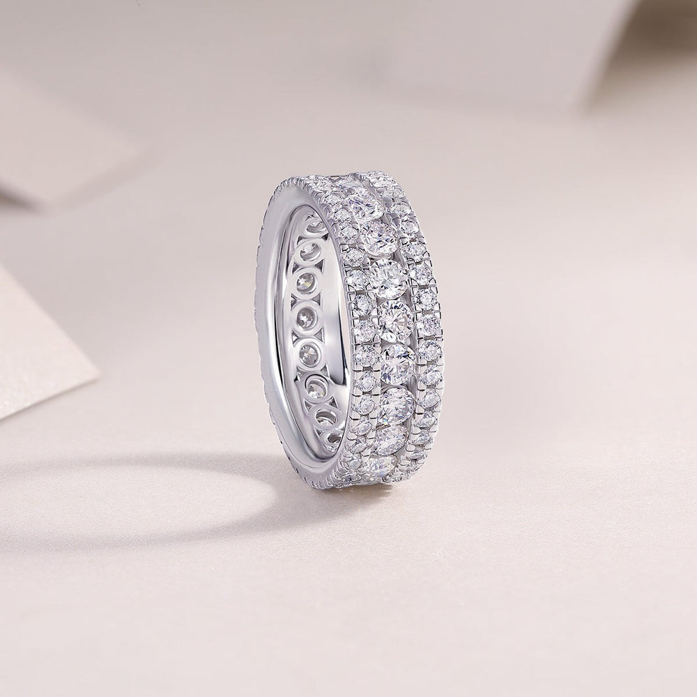Side profile of triple-row pavé moissanite wedding band, three rows of round stones, white metal