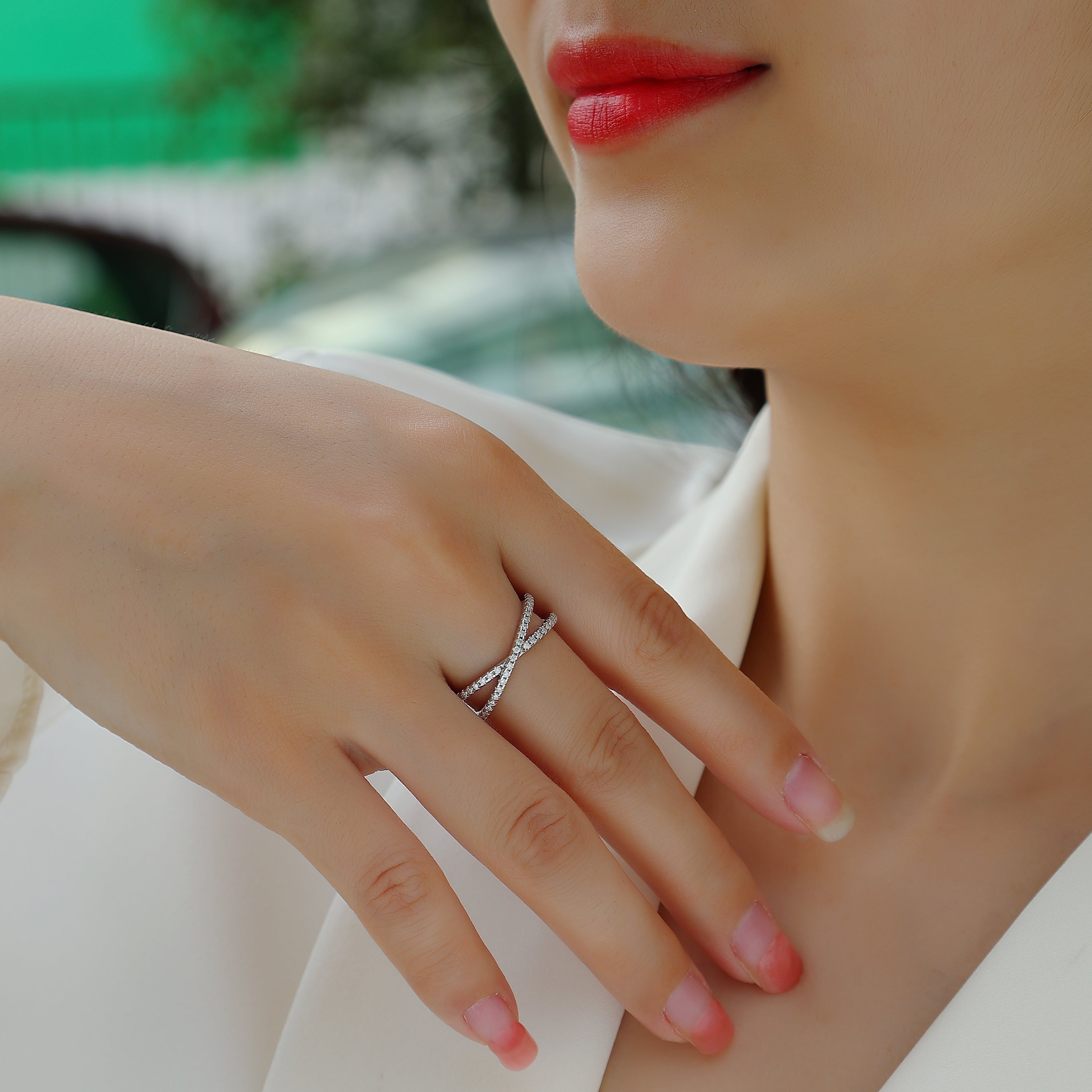 Worn X-Cross Moissanite pavé band with clear stones on a slim white metal crossover