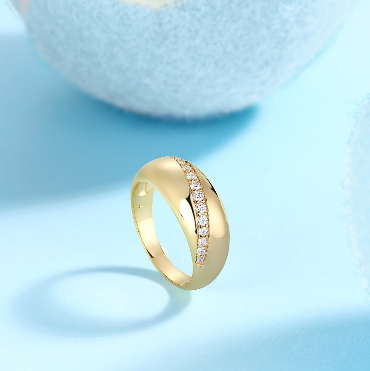 Yellow gold vermeil dome band with a row of white moissanite stones