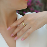 Ring on finger: yellow gold vermeil dome band with star-shaped moissanite stones