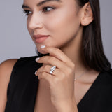 Three-round moissanite engagement ring on finger, white gold-plated band